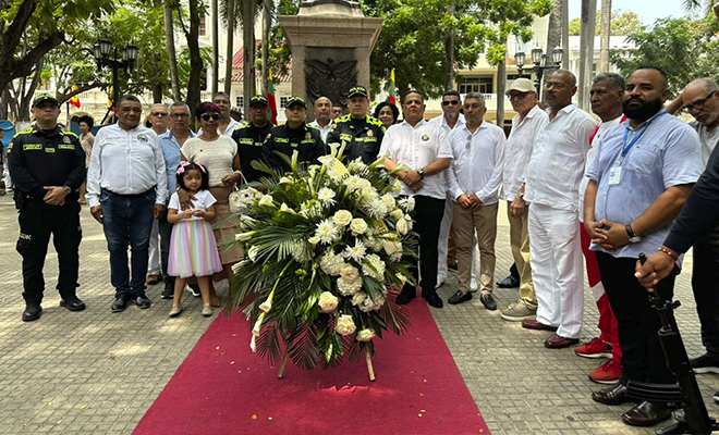 policias  y familias con ofrenda floral