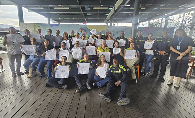 Policías y comunidad sonriendo para la foto con manualidades terminadas