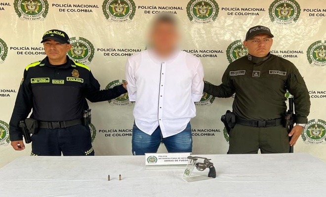 Persona capturada con un arma de fuego y dos policías 