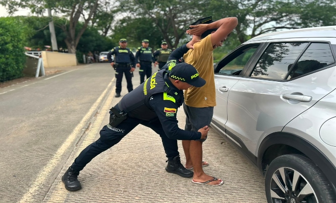 cuatro uniformados de la Policía nacional  realizan registro a un ciudadano en la vía de ciénega de oro cordóba 