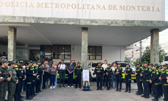 Grupo de funcionarias de la Policía Nacional rindiendo en minuto de silencio frente a las instalaciones del comando de la Policía Metropolitana de Montería