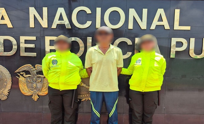 Dos policías junto al capturado por amenazas