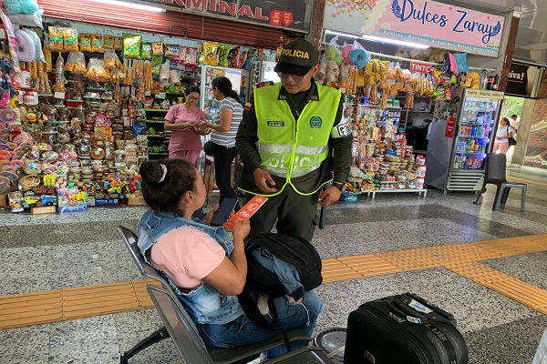 Polic&iacute;a compartiendo folleto informativo a una ciudadana